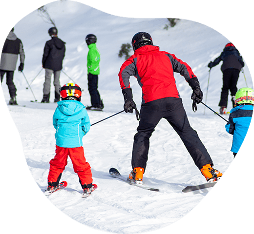 Happy family enjoying their time on a ski trip, skiing and having fun on a snowy mountain