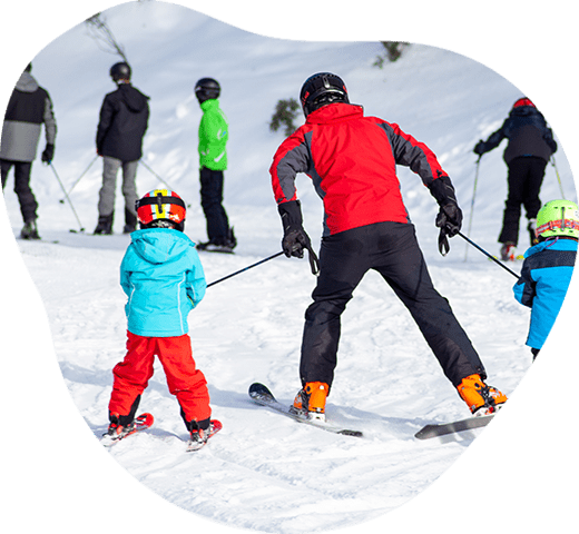 Happy family enjoying their time on a ski trip, skiing and having fun on a snowy mountain