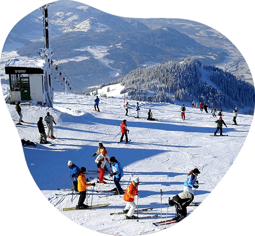 Children walking with snowshoes in winter landscape